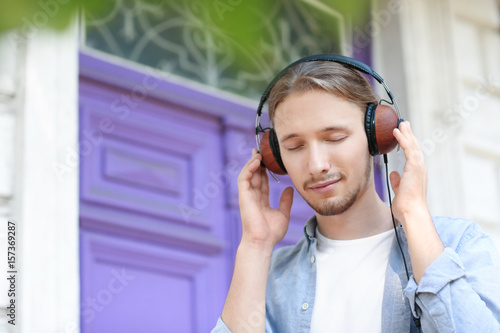 Handsome young man listenin...