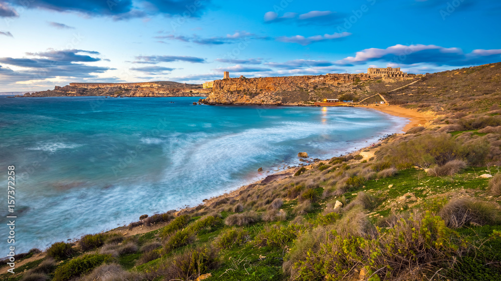 Mgarr, Malta - The famous Ghajn Tuffieha bay at blue hour on a long exposure shot with beautiful sky and clouds