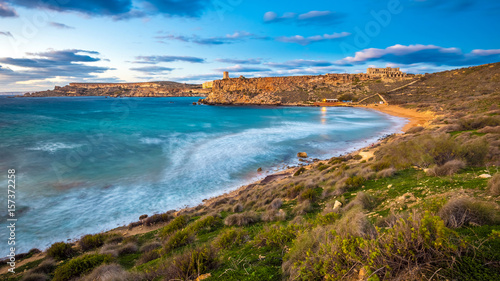 Mgarr, Malta - The famous Ghajn Tuffieha bay at blue hour on a long exposure shot with beautiful sky and clouds