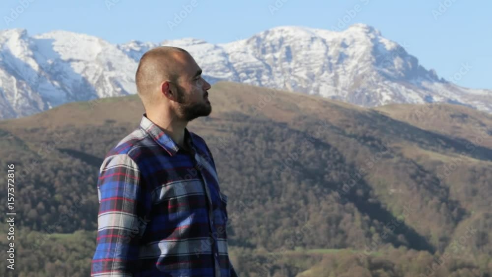 Handsome bald hiker, in nature eats a bread at beautiful mountain landscape. Handsome bald hiker, in nature eats a bread at beautiful mountain landscape.