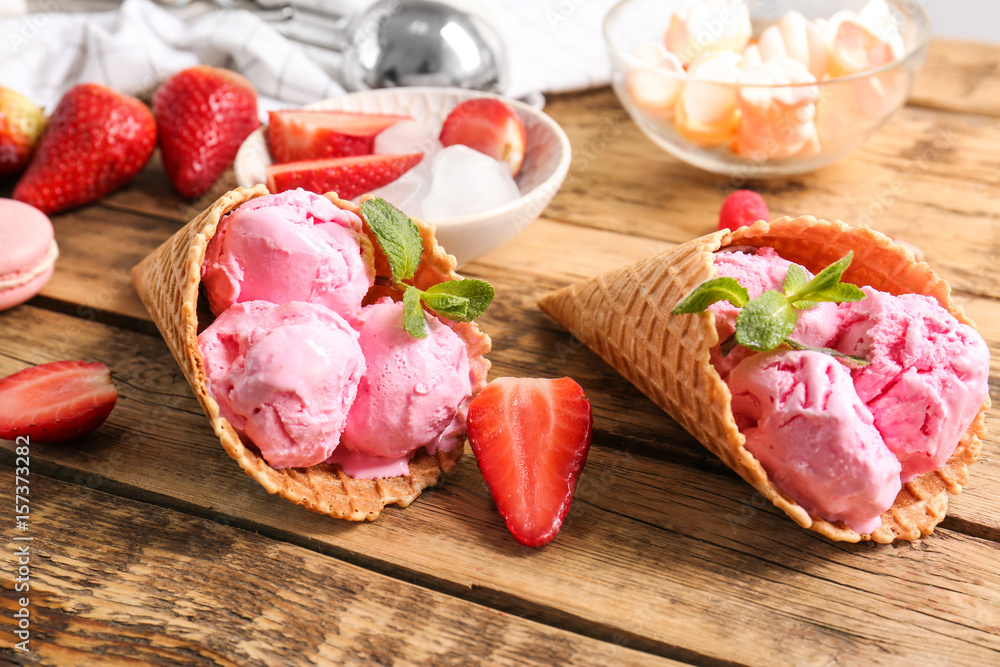 Strawberry ice-cream cones on wooden background Strawberry ice-cream cones on wooden background