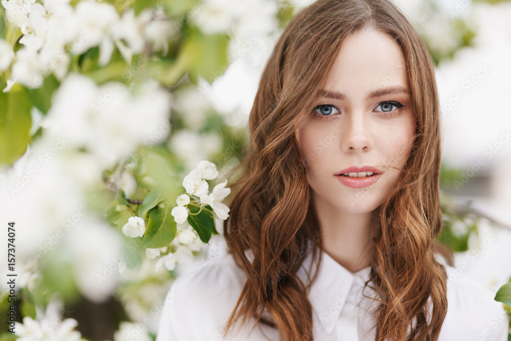 Portrait of young beautiful woman on green flower background in summer Portrait of young beautiful woman on green flower background in summer