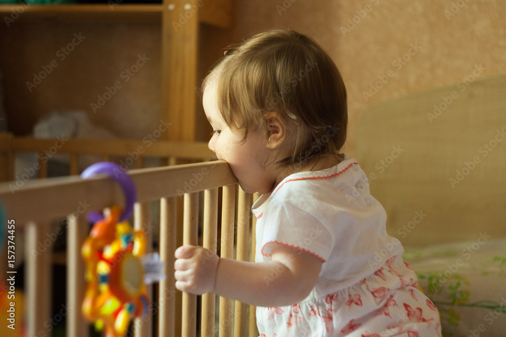 Teething infant is biting railing of cribs Teething infant is biting railing of cribs