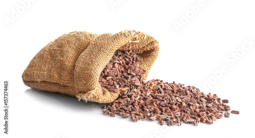 Textile sack with cocoa nibs on white background
