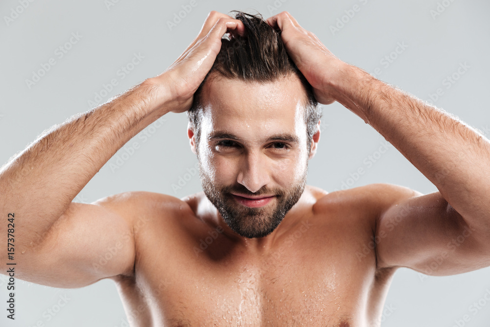 Handsome man standing isolated over grey background Handsome man standing isolated over grey background
