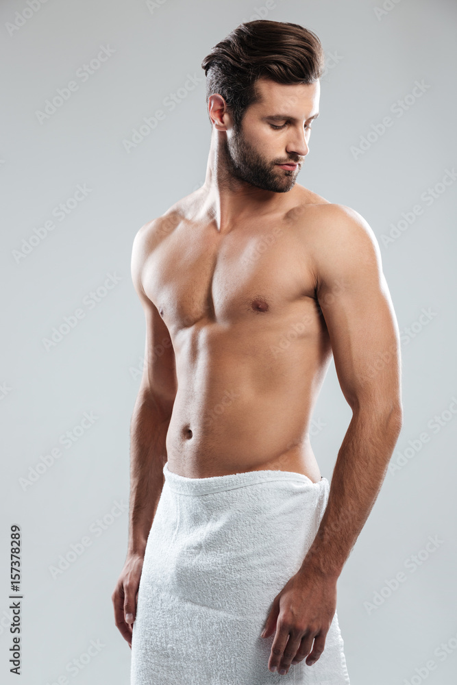 Fototapeta premium Handsome young man dressed in towel