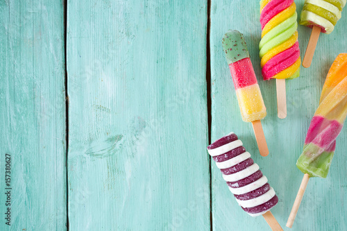 colorful popsicle ice cream on turquoise wooden background