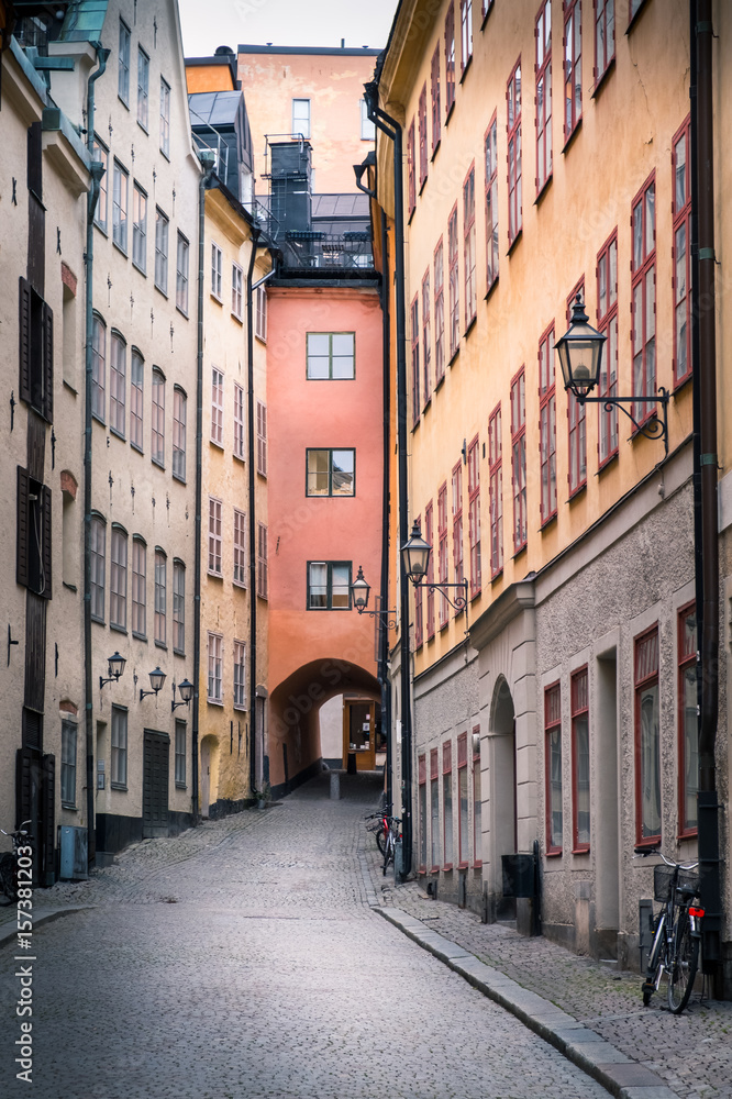 STOCKHOLM, SWEDEN - October 14, 2016: View from narrow and idyllic street with colorful buildings in Gamla Stan. The Old Town in Stockholm, Sweden. Cloudy day.