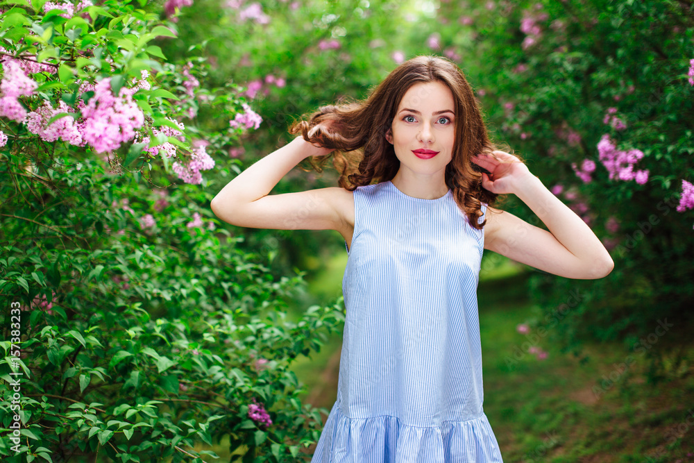 Young girl stand at park background with bouquet of flowers Young girl stand at park background with bouquet of flowers