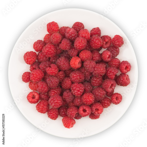 Plate with fresh raspberries on white background.