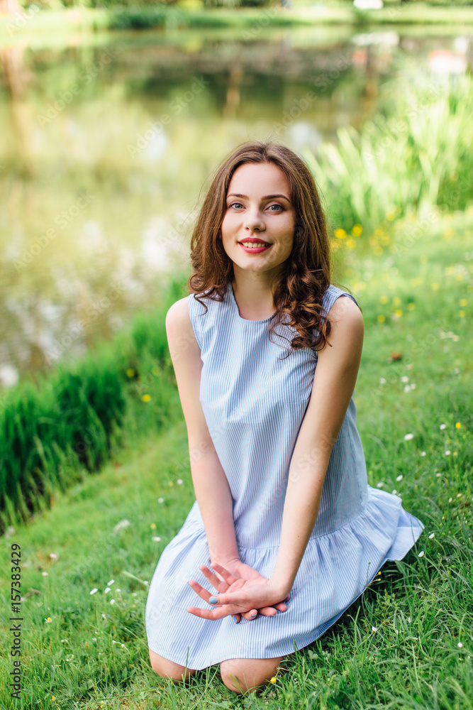 Young girl stand at park background with bouquet of flowers Young girl stand at park background with bouquet of flowers
