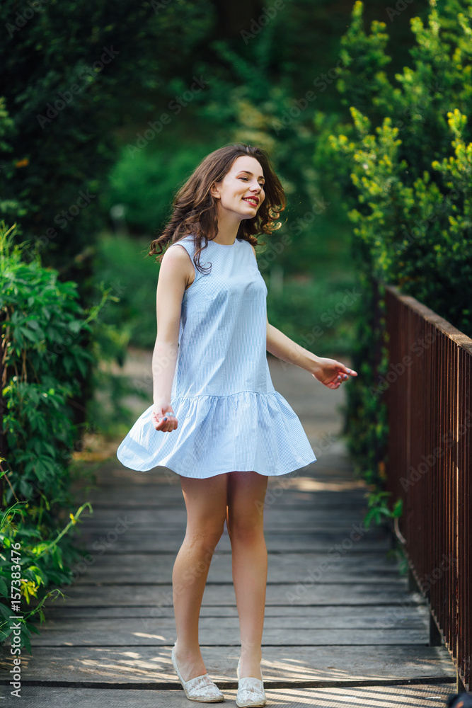 Girl pose to camera at park background with her dress Girl pose to camera at park background with her dress
