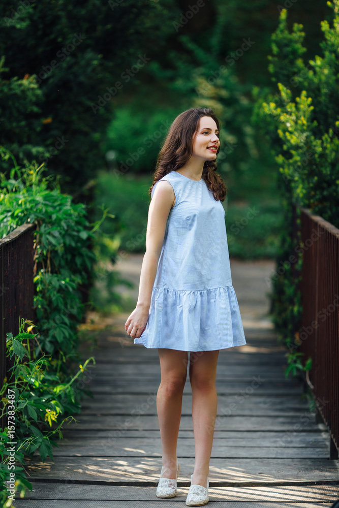 Girl pose to camera at park background with her dress Girl pose to camera at park background with her dress