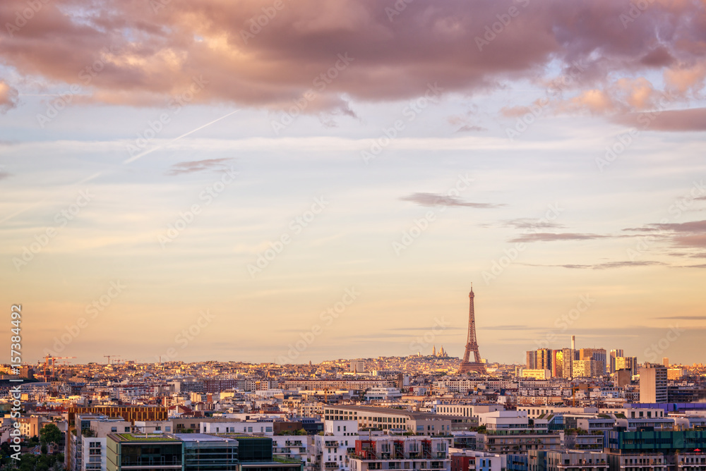 Aerial scenic view of Paris with the Eiffel tower at sunset, Montmartre in the background, France and Europe city travel concept