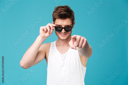 Young happy man pointing