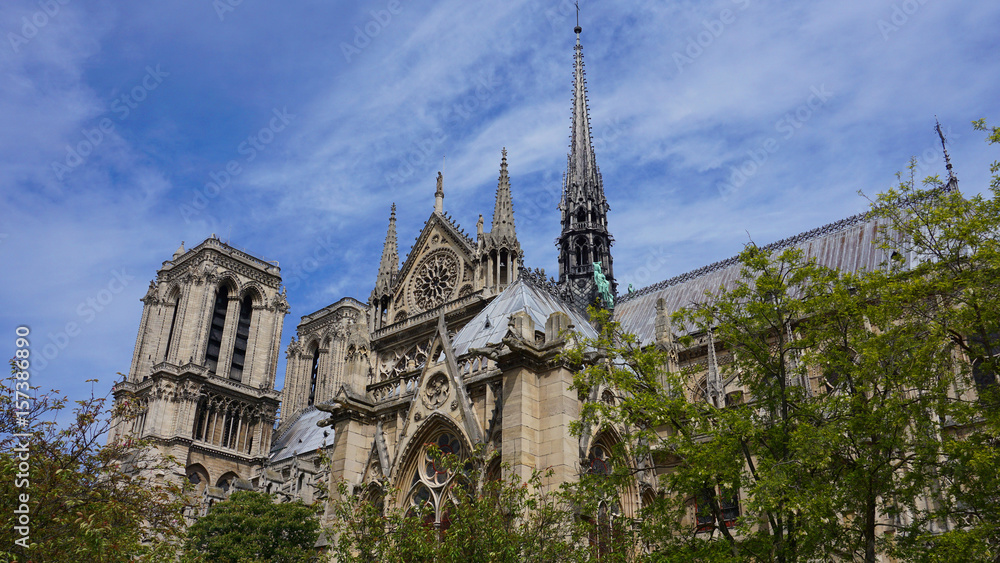 Photo of famous Notre Dame cathedral on a cloudy spring morning, Paris, France Photo of famous Notre Dame cathedral on a cloudy spring morning, Paris, France