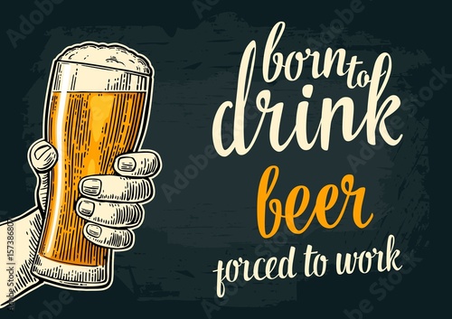Male hand holding beer glass. Born to drink beer forced to work