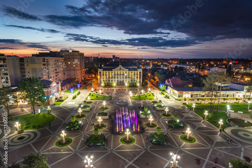 Beautiful aerial panorama of Irpin city center at evening time with working colorful fountains and central square of Irpin, Ukraine photo