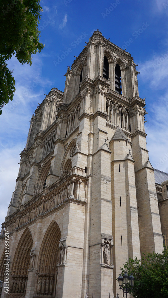 Photo of famous Notre Dame cathedral on a cloudy spring morning, Paris, France Photo of famous Notre Dame cathedral on a cloudy spring morning, Paris, France