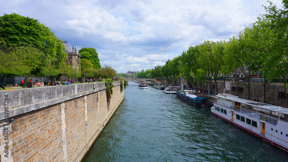 Photo of famous Notre Dame cathedral on a cloudy spring morning, Paris, France