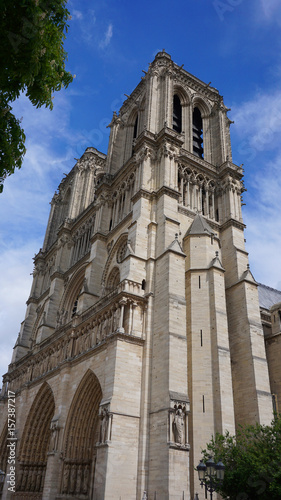 Photo of famous Notre Dame cathedral on a cloudy spring morning, Paris, France