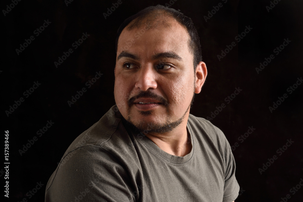Portrait of a latin man on black background