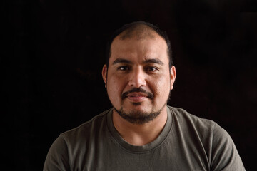 Portrait of a latin man on black background