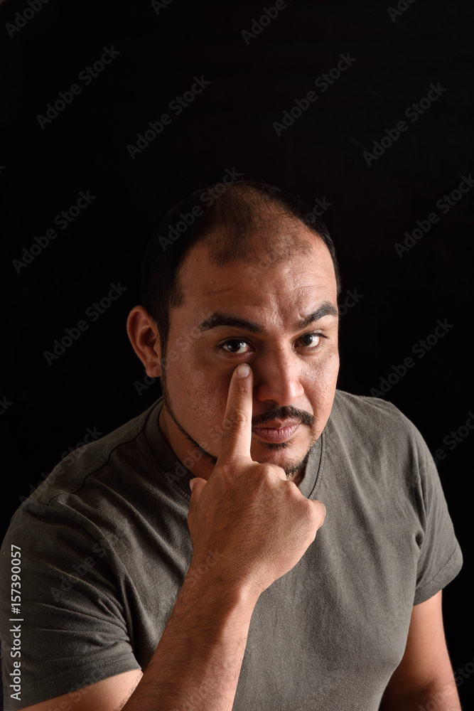Man with finger pointing eye Man with finger pointing eye