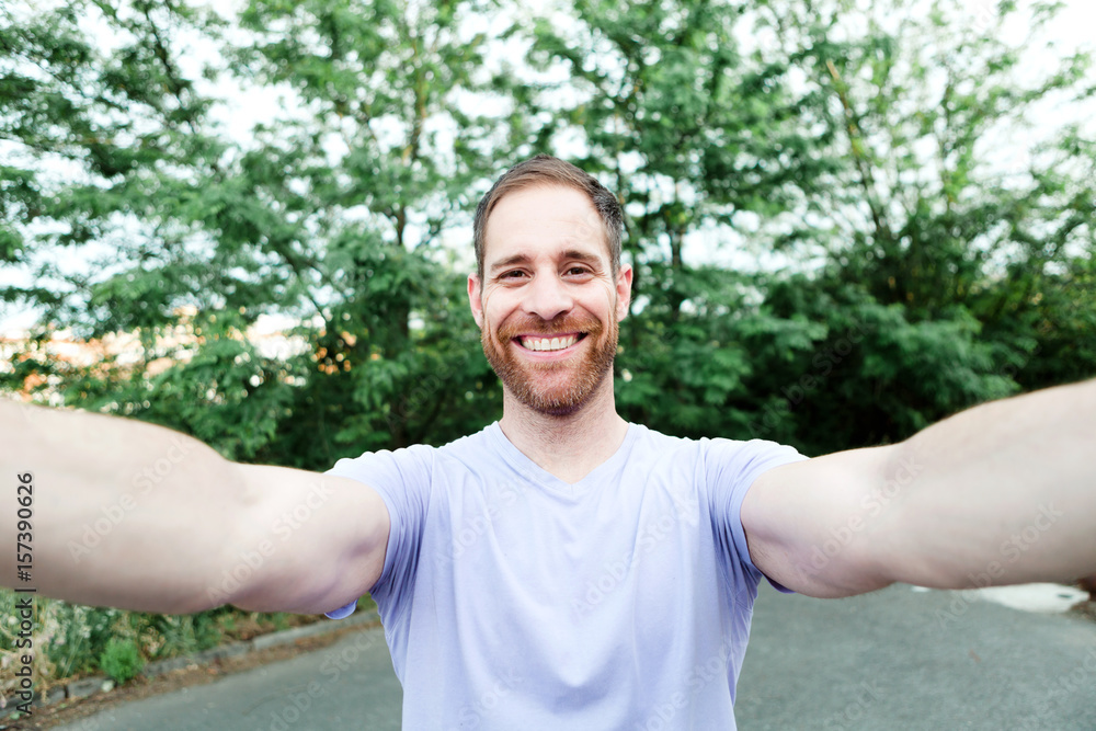 Casual guy in a park taking a photo Casual guy in a park taking a photo