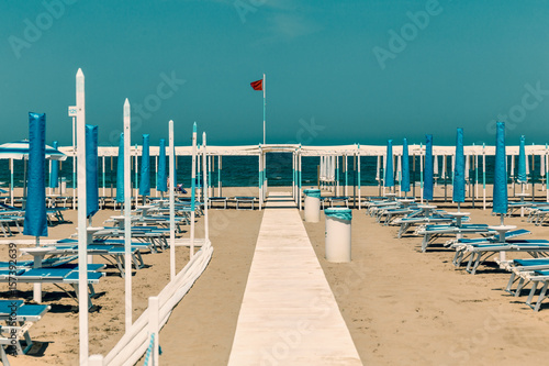 sand beach with chaise longue and umbrellas Riccione, rimini, italy