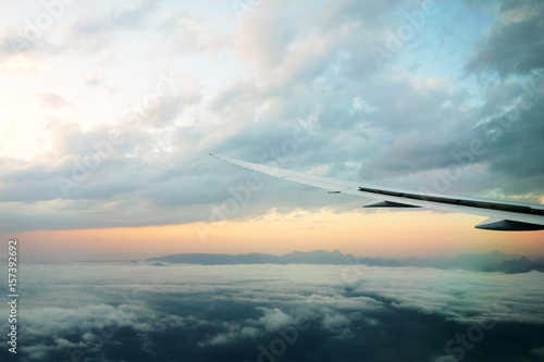 Wings of an airplane in between clouds