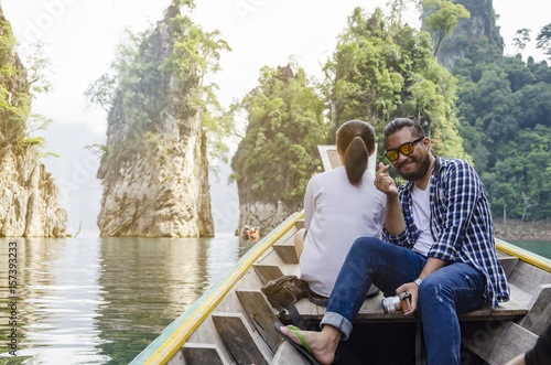 Man enjoying to adventure trip of a lifetime floating in a boat on the asia lake.