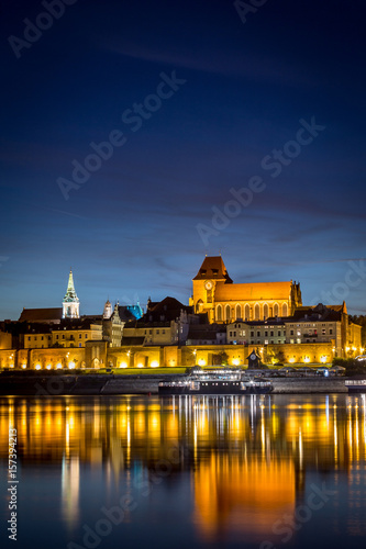 Torun's Old Town panorama with its reflection in Vistula river at the evening