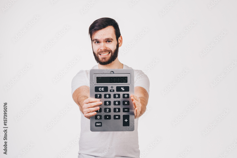 unshaved man in white t-shirt shows a big calculator unshaved man in white t-shirt shows a big calculator