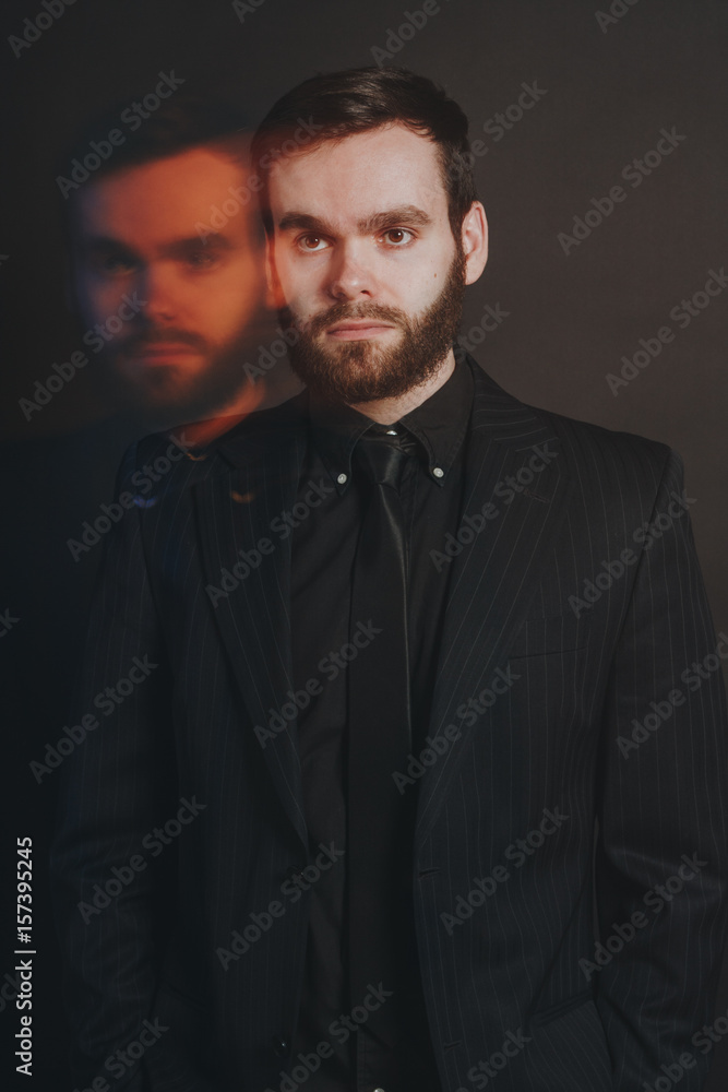 handsome unshaved man on  black background with special effects