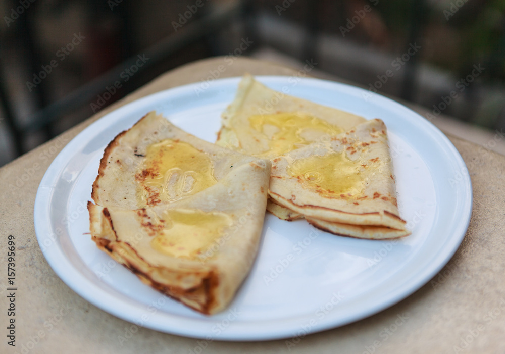 Plate with two pancakes with butter served on white plate Plate with two pancakes with butter served on white plate
