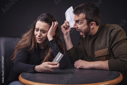 Husband and wife fighting over money and expenses, loudly and passionately photo