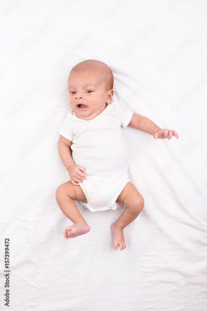Newborn baby on white sheet Newborn baby on white sheet