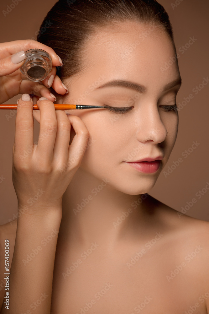 Obraz premium Beautiful female eyes with make-up and brush