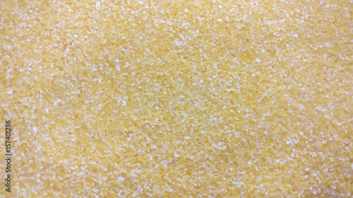 Great background of Dried milled corn grains (Corn groats) are rotating close up.  Footage will work great for any videos dealing with cooking, health nutrition and much more.