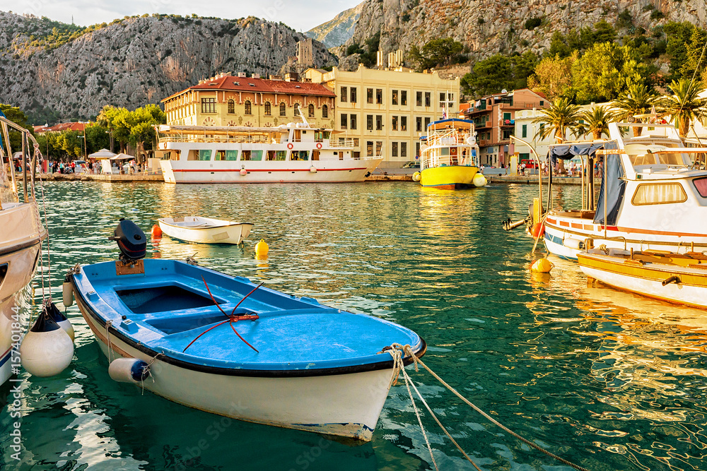Boats and ferries at harbor in Adriatic Sea in Omis, Croatia