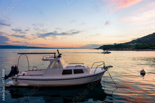 Boat at harbor in Adriatic Sea in Omis at sunset