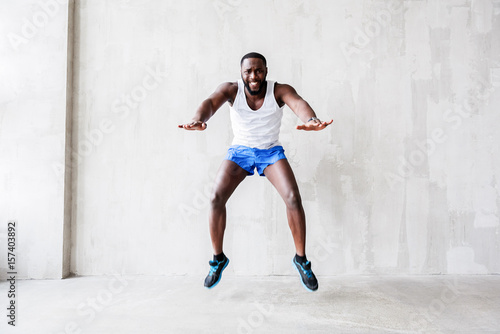 Bearded african athlete showing enormous effort while jumping © Yakobchuk Olena
