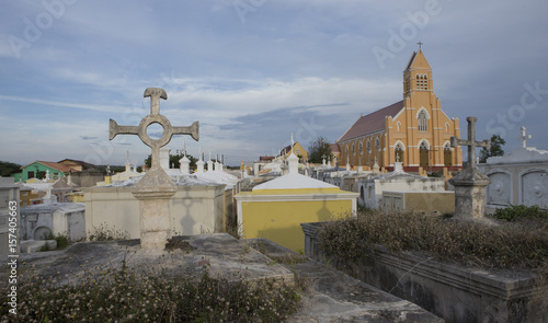 Sint Willibrordus Church and cemetry at Curacao. Graveyard with thombstones. photo