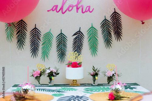 Birthday / Wedding party table decoration with aloha hawai sign and pink balloons