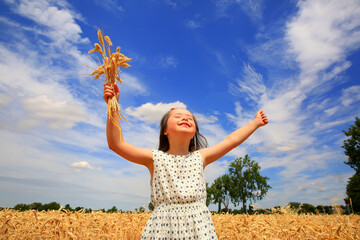 Young girl have fun in the wheat field
