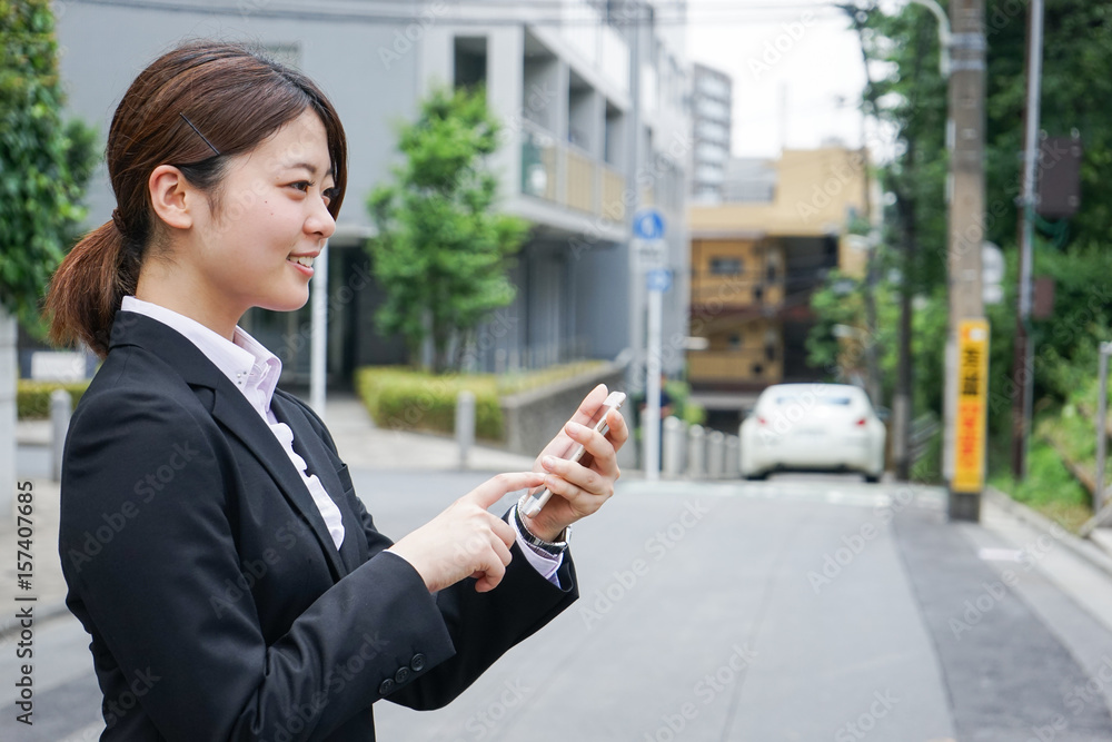 Young businesswoman searching for a destination with her smartphone Young businesswoman searching for a destination with her smartphone