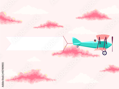 Airplane with pilot and advertising banner in the cloudy sky