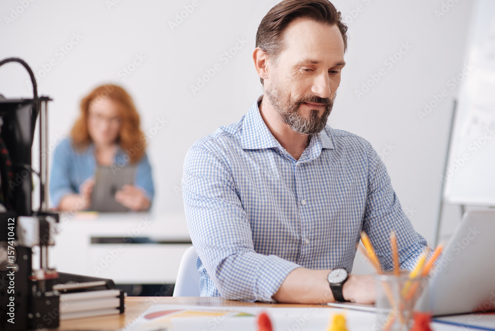 Handsome nice serious man working on the laptop Handsome nice serious man working on the laptop