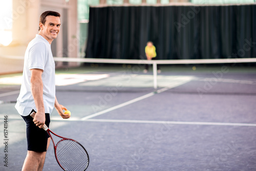 Cheerful guy enjoying tennis game © Yakobchuk Olena